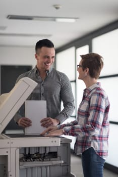 happy business people group at modern office copy  documents on machine