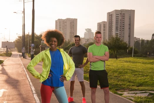 Portrait of multi-ethnic group of young people on the jogging beautiful summer evening as the sun sets over the city