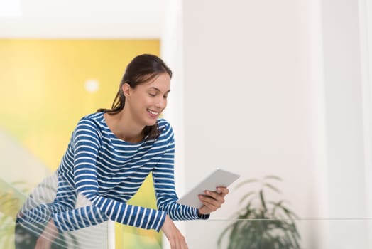 beautiful young woman at home websurfing on internet with tablet