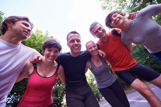 jogging people group, friends have fun,  hug and stack hands together after training