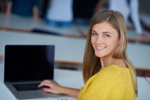portrait of happy smilling student girl at tech classroom with laptop computer in background