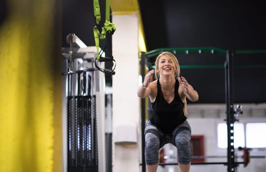 young athletic woman training  jumping on fit box at cross fitness gym