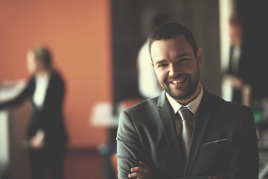happy young business man portrait  at modern meeting office indoors