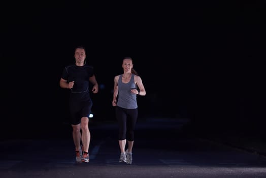 urban sports, healthy couple jogging in the city at early morning in night