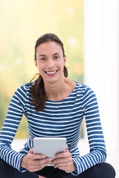 beautiful young women using tablet computer on the floor at home