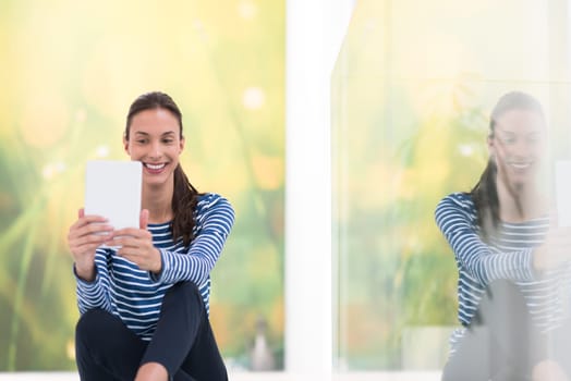 beautiful young women using tablet computer on the floor at home