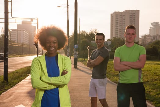Portrait of multi-ethnic group of young people on the jogging beautiful summer evening as the sun sets over the city