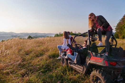 portrait of group young happy people enjoying beautiful sunny day while driving a off road buggy car on mountain nature