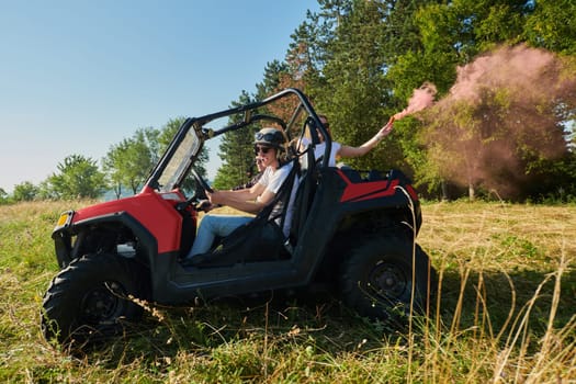group of young happy excited people having fun enjoying beautiful sunny day holding colorful torches while driving a off road buggy car on mountain nature