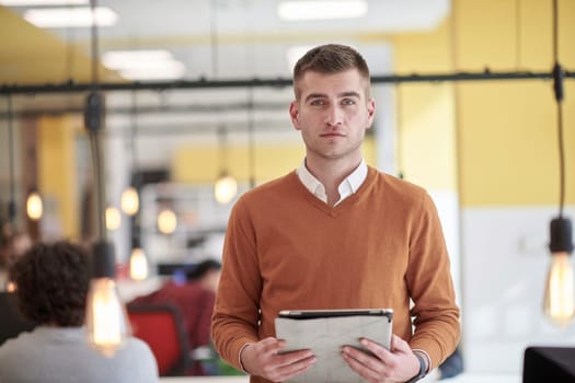 businessman portrait in modern startup business coworking space with bulb decoration representing concept of innovation and idea
