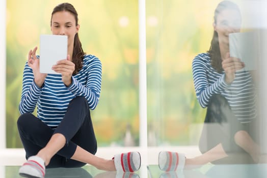 beautiful young women using tablet computer on the floor at home