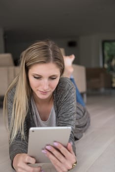 beautiful young women used tablet computer on the floor of her luxury home