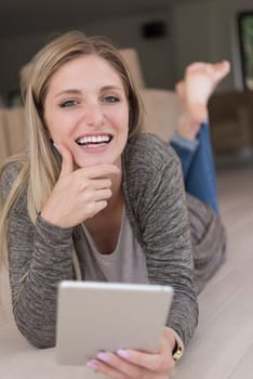beautiful young women used tablet computer on the floor of her luxury home