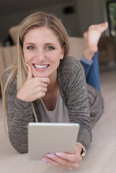 beautiful young women used tablet computer on the floor of her luxury home