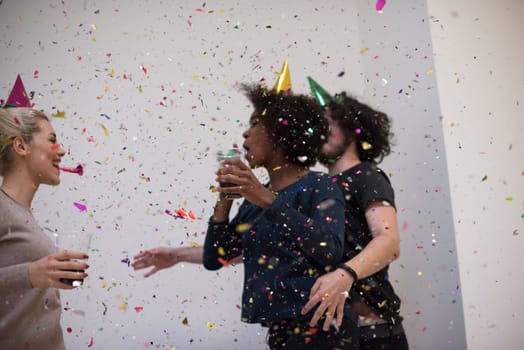 confetti party Multiethnics happy young people group celebrating new year eve while dancing and have fun at home