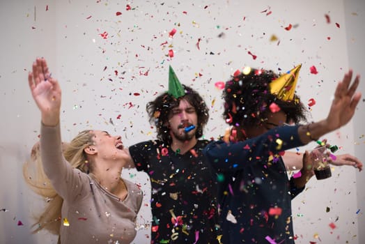 confetti party Multiethnics happy young people group celebrating new year eve while dancing and have fun at home