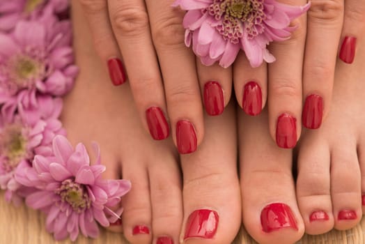 Closeup photo of a female feet and hands at spa salon on pedicure and manicure procedure