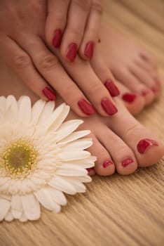 Closeup photo of a female feet and hands at spa salon on pedicure and manicure procedure