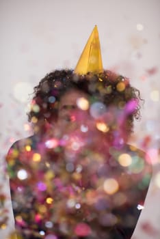 young man on party celebrating new year with falling confetti