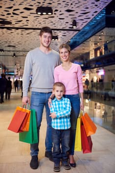 happy  young family with shopping bags in mall