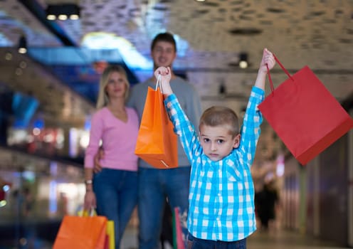 happy  young family with shopping bags in mall