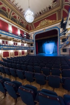 empty theater stage curtain with dramatic lights