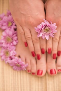 Closeup photo of a female feet and hands at spa salon on pedicure and manicure procedure