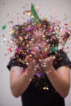 young man on party celebrating new year with falling confetti