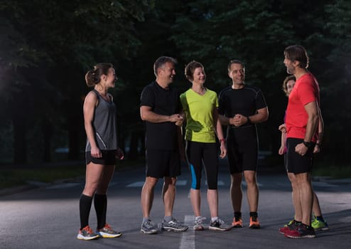 group of healthy people jogging in city park, runners team on morning training