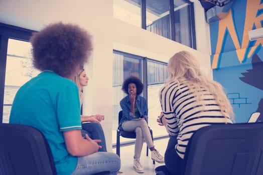 Multiethnic startup business team on meeting in modern bright office interior brainstorming, working on laptop and tablet computer