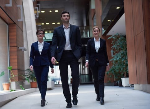 young business people team walking, group of people on modern office hall interior