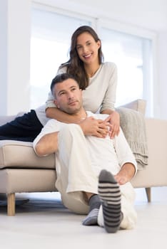 Portrait of a happy young beautiful couple hugging in their new home