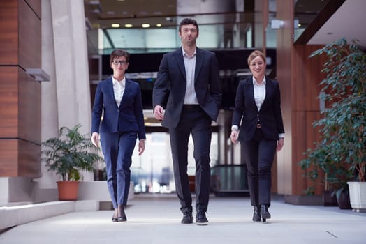 young business people team walking, group of people on modern office hall interior