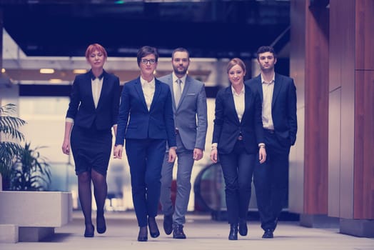 young business people team walking, group of people on modern office hall interior