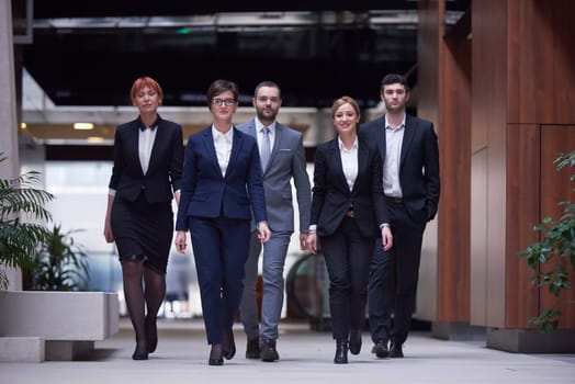 young business people team walking, group of people on modern office hall interior