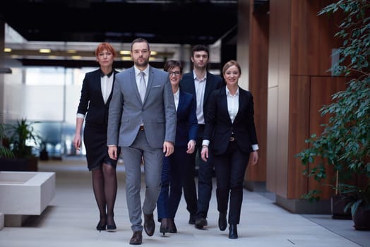 young business people team walking, group of people on modern office hall interior