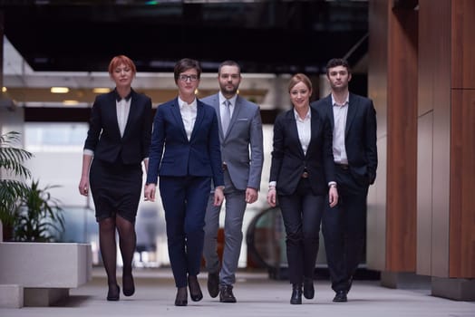young business people team walking, group of people on modern office hall interior