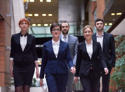 young business people team walking, group of people on modern office hall interior