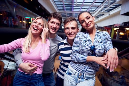 group of happy  friends in shopping mall have fun