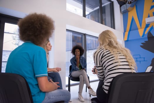 Multiethnic startup business team on meeting in modern bright office interior brainstorming, working on laptop and tablet computer