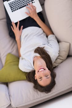 Young woman using her laptop computer in her luxury modern home top view