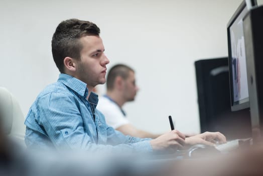 photo editors working with graphic tablet and pen on photographs in retouching studio