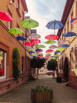 Street in German town decorated with umbrellas. Europe travel and decorations.