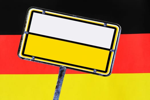 An empty yellow German street sign in front of Germany flag