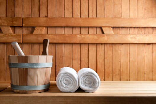 Detail of bucket and white towels in a sauna