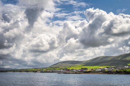 Beautiful Portmagee village, view from the sea, located at the edge of Atlantic Ocean with dramatic sky, Ring of Kerry, Wild Atlantic Way, Ireland