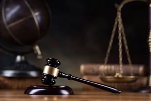 Law theme, mallet of judge, wooden gavel, globe background
