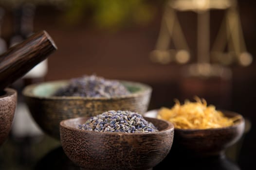 Alternative health, fresh herbal and mortar in black mirror background