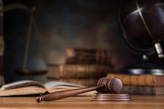 Law theme, mallet of judge, wooden gavel, globe background