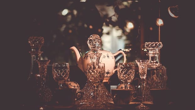 Set of Vintage crystal glasses on the black tray with Christmas decorations. Selective focus